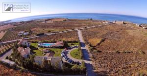 an aerial view of a house on a hill with the ocean at Monachus Monachus in Frangokastello