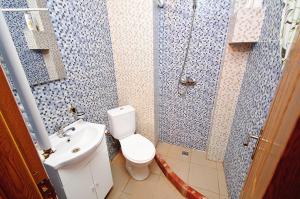 a bathroom with a toilet and a sink and a shower at Apartament Gina2 in Galaţi