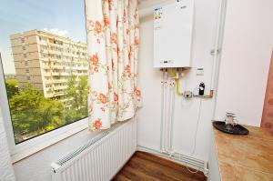 a kitchen with a window with a radiator and a radiator at Apartament Gina2 in Galaţi
