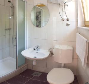 a bathroom with a toilet and a sink and a shower at Apartments Beautiful Sandy Beach in Split