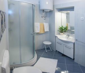 a bathroom with a shower and a toilet and a sink at Apartments Beautiful Sandy Beach in Split +36 photos