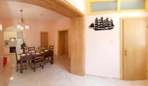 a dining room with a table with a ship on the wall at Apartments Beautiful Sandy Beach in Split
