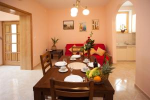 a dining room with a table with fruit on it at Apartments Beautiful Sandy Beach in Split
