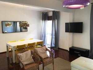 a living room with a dining room table and chairs at Lemon Tree Apartments in Faro