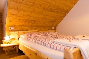 a bed in a room with a wooden ceiling at Baumgartner - Bauernhaus in Weißkirchen in Steiermark