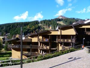 a group of buildings with a mountain in the background at Bilocali Alberti - Des Alpes in Madonna di Campiglio