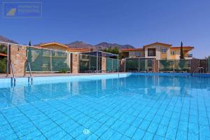 a large swimming pool with blue water at Monachus Monachus in Frangokastello