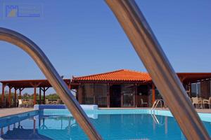 a view of a swimming pool through a pair of windows at Monachus Monachus in Frangokastello