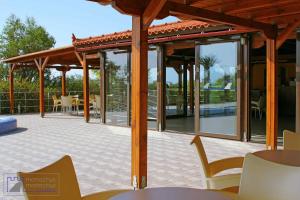 a pavilion with tables and chairs on a patio at Monachus Monachus in Frangokastello