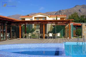a house with a deck and a swimming pool at Monachus Monachus in Frangokastello