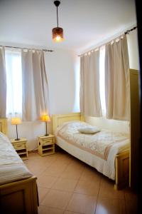 a bedroom with two beds and two windows at Villa Bulgara Eco in Madara +34 photos