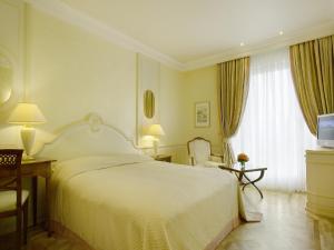 Postel nebo postele na pokoji v ubytování Colombi Hotel
