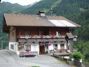 a house with flowers in front of it at Rieplerhof in Matrei in Osttirol
