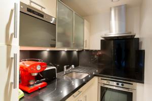 a kitchen with a red mixer on a counter at Foch triomphe in Paris