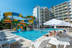 a pool with a water slide in a resort at Best Western PLUS Premium Inn in Sunny Beach