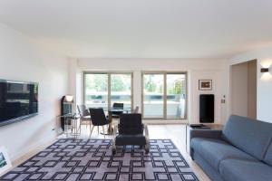 a living room with a couch and a table at Foch triomphe in Paris