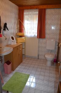 a bathroom with a toilet and a sink and a mirror at Rieplerhof in Matrei in Osttirol +45 photos