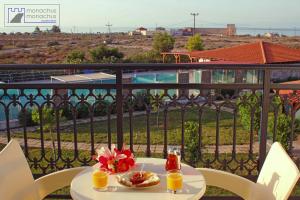 a table with food and drinks on a balcony at Monachus Monachus in Frangokastello