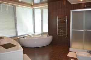 a large bathroom with a tub and two sinks at Villa Kobuleti in Kobuleti +24 photos