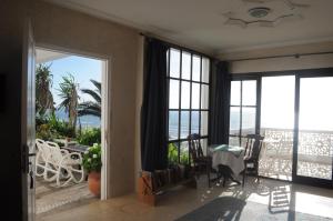 a living room with a view of the ocean at Villa Nora in Moulay Bousselham