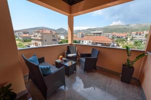 a balcony with chairs and a table and a view at Apartments Robi in Trogir