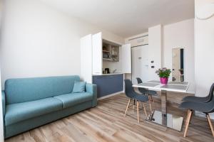 a living room with a blue couch and a table at Aparthotel Isola in Milan