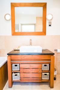 a bathroom with a sink and a mirror at Fleur Du Jardin in Kings Mills