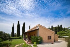 a building with a bunch of trees in the background at B&B 8380 Saturnia Terme in Saturnia