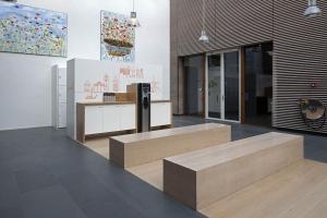 a room with a counter with benches and a painting at easyHotel Amsterdam Zaandam in Zaandam