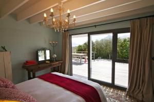 a bedroom with a bed and a large sliding glass door at Seabreeze in Kommetjie +52 photos