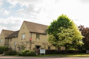 a large house with a tree in front of it at The Churchill Court in Woodstock