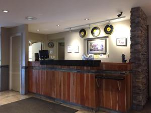 a lobby of a hotel with a reception counter at Bear Country Inn in Terrace