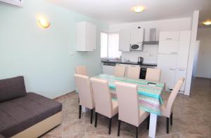 a kitchen and dining room with a table and chairs at Amazing sea view apartments Ljubic in Pag