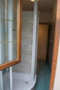 a bathroom with a shower and a toilet and a tub at Appartamento Marocche in Nago-Torbole +82 photos
