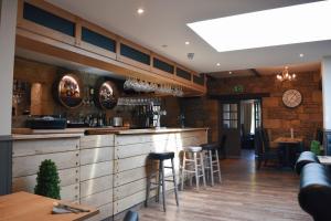 a bar in a restaurant with stools and a counter at The Apple Inn in Lucker