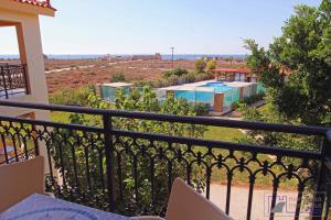 a balcony with a view of a pool at Monachus Monachus in Frangokastello