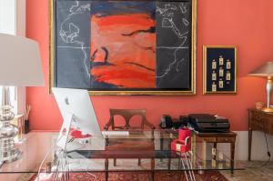 a living room with a painting on the wall at Dear Lisbon - Palace Chiado Suites in Lisbon