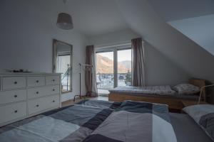 a bedroom with a bed and a dresser and a window at Apartments Teja in Kranjska Gora