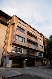 a building with a sign on the side of it at Izumiya Ryokan in Kyoto