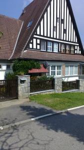 a house with a black and white building at Byt - apartman in Větřní