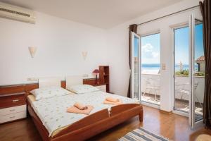 a bedroom with a bed with two towels on it at House Coko in Baška Voda