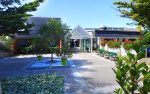 a building with a bunch of plants and flowers at VVF Les Plages de Guérande La Turballe in La Turballe