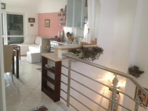 a living room with a staircase and a kitchen at Apartments Paradiso in Budva