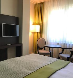 TV a/nebo společenská místnost v ubytování Hotel Alex