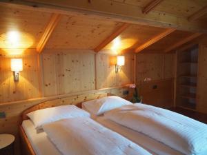 a bedroom with two beds in a room with two lights at Tannenhof - Lofer in Lofer