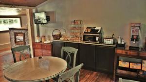 a kitchen with a table and a counter with a microwave at Riverside Lodge at Chimney Rock in Chimney Rock +70 photos