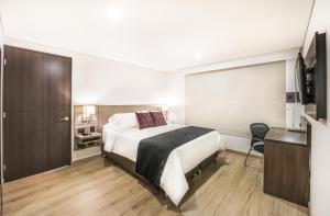 Postel nebo postele na pokoji v ubytování SM Grand Hotel