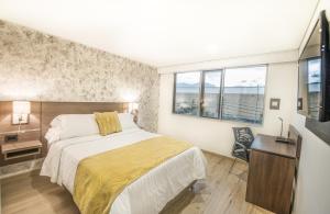 Postel nebo postele na pokoji v ubytování SM Grand Hotel