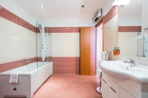 a bathroom with a tub and a sink and a shower at Apartment Eli Kacjak in Dramalj +23 photos