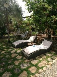 two bean bag chairs and a table in a yard at Hemdatya Stone Suites In The Galilee in Ilaniya